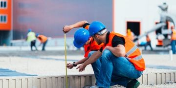 construction team measuring a small wall