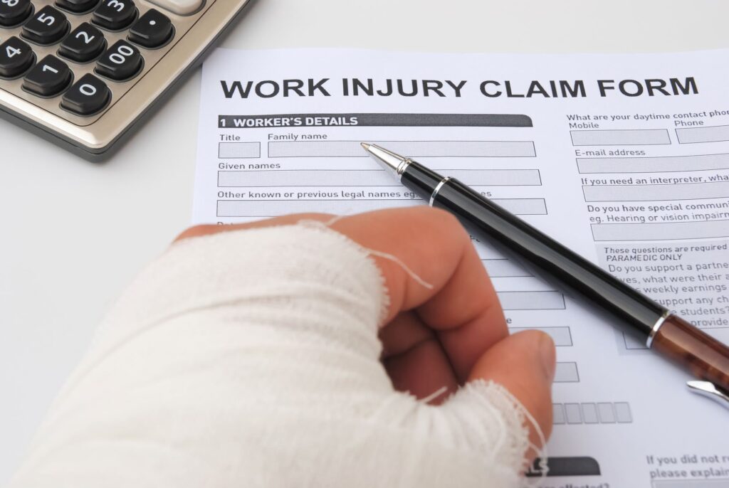 A person with hand and work injury filling claim form